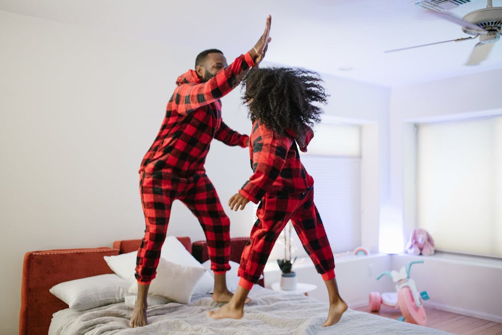 Daughter Playing on Bed with Father