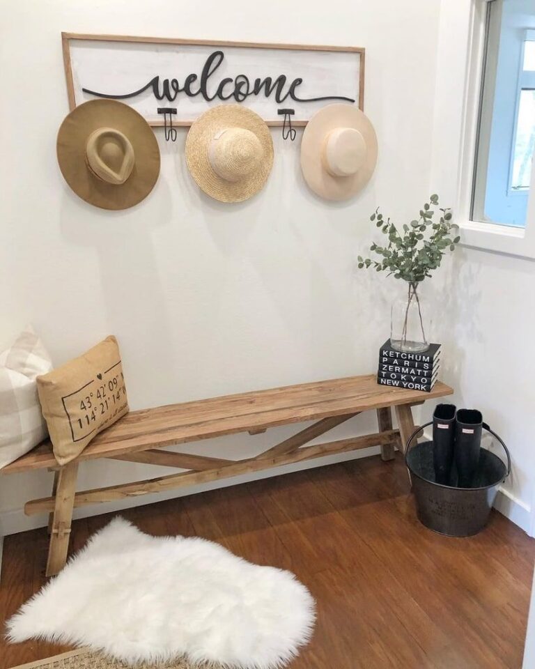 Rustic wooden entryway bench with welcome sign and decorative sun wall art.