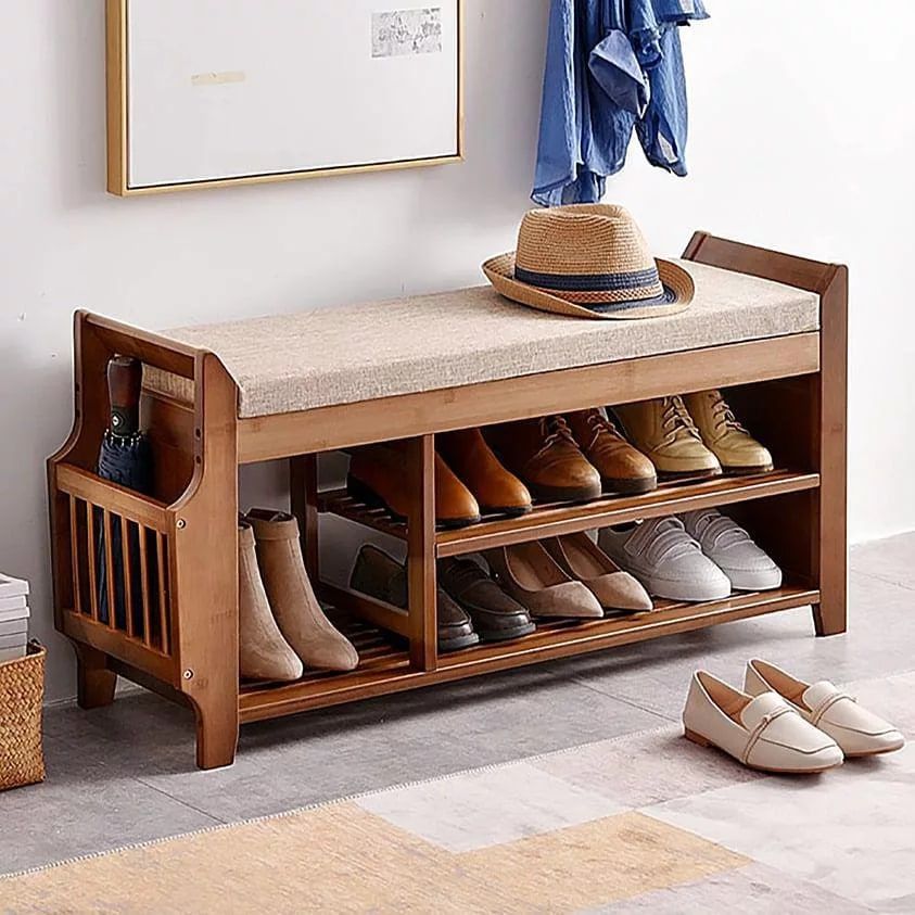 Natural wood shoe bench with cushioned top and open shelving for entryway shoe storage.